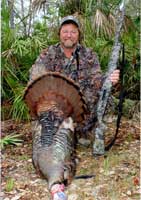 Man posing behind turkey