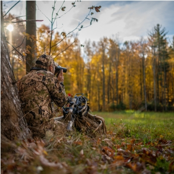 hunter using optics to look for wild game